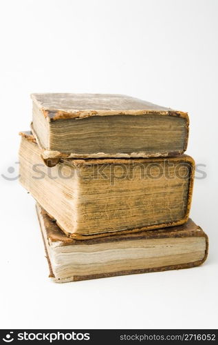 Antique books piled on a white background