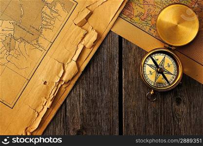 Antique brass compass over old map
