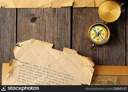 Antique brass compass over old map