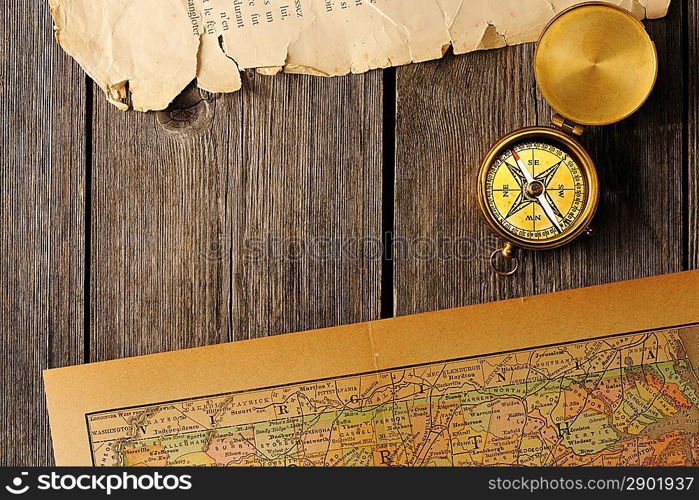 Antique brass compass over old map