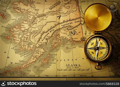 Antique brass compass over old XIX century map