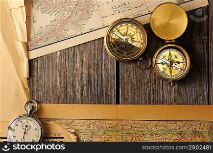Antique brass compasses over old map