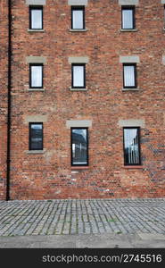 antique brick wall building with windows (british architecure in Gloucester, England, UK)