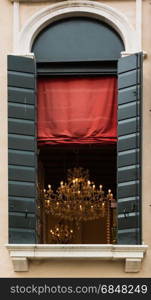 Antique Brilliant Chandelier with Crystal inside Window and Red Curtain