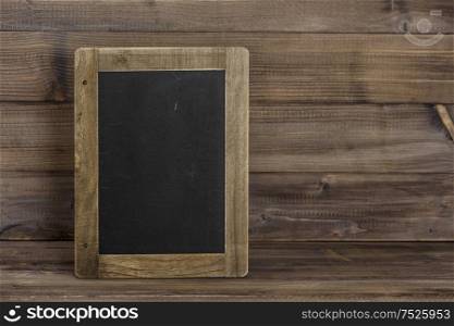 Antique chalkboard on wooden texture. Rustic background with copyspace for your text