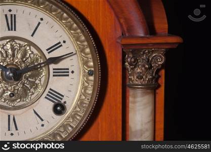 antique clock close up on black background