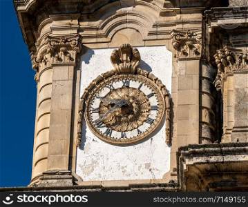 Antique clock on the Santuario de Nossa Senhora dos Remedios at the top of the baroque staircase above Lamego. Ornate clock on the Our Lady of Remedies church above the city of Lamego