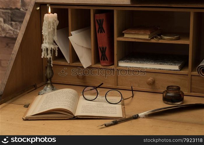 Antique desk with his pen and old books
