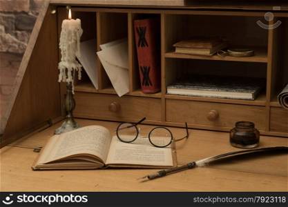 Antique desk with his pen and old books