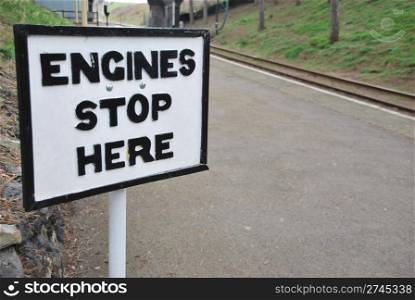 antique engines stop here sign at a british train station