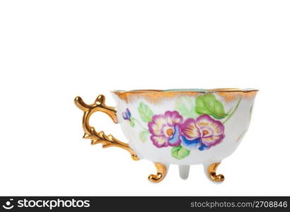 Antique footed tea cup with ornate handle. Shot on white background.