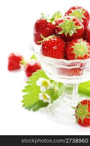 Antique glass filled with fresh tasty strawberries over white