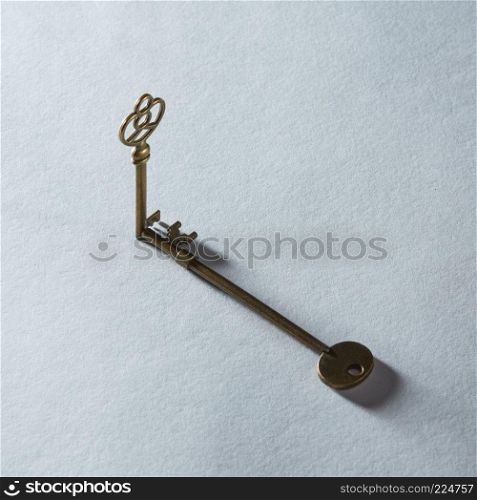 Antique golden door keys with shadow isolated on grey background. Blank copy space may be used for any emotions, ideas, feelings.. Key represented on background