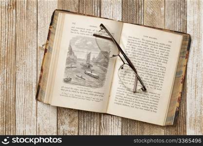 antique illustrated book with reading glasses on grunge white painted wood table, Rob Roy in the Baltic by J. MacGregor published in 1867, out of copyrights
