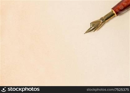 Antique ink pen on grungy paper texture. Vintage style background