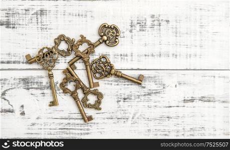Antique keys on rustic wooden background. Nostalgic still life