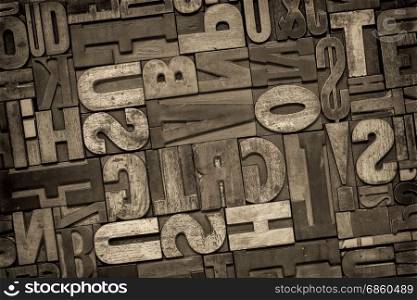antique letterpress printing blocks, random collection of different size and style, black and white, sepia toned image