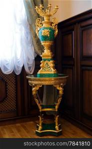 antique malachite candlestick standing by the window