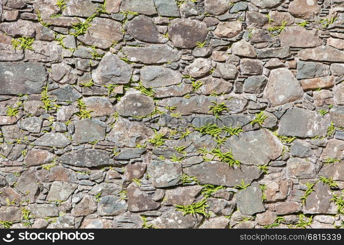 Antique natural stonewall, old stones in different sizes