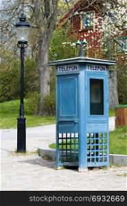 Antique phone booth blue and old lantern