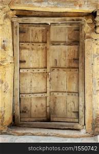 Antique rustic ancient wooden door. Architectural element.. Antique rustic ancient wooden door.
