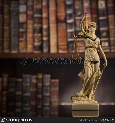 Antique statue of justice, law, books background. Judge gavel and scales of justice and book background