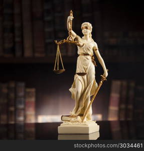 Antique statue of justice, law, books background. Judge gavel and scales of justice and book background