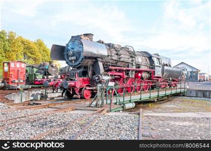 Antique steam locomotive in depot