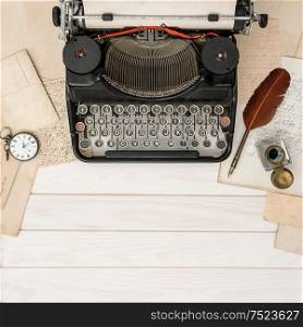 Antique typewriter and vintage office tools on wooden table. Flat lay still life