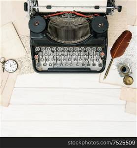 Antique typewriter and vintage office tools on wooden table. Flat lay still life. Reto style toned picture