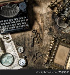 Antique typewriter and vintage office tools on wooden table. Nostalgic still life