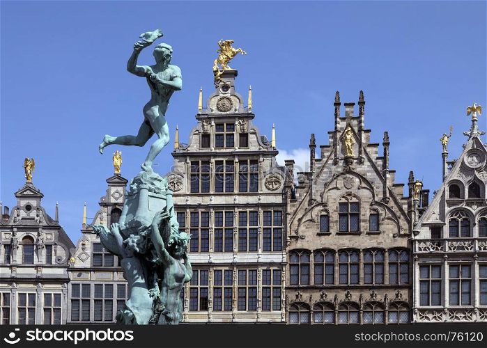 Antwerp - Belgium. Statue of Silvius Brabo throwing the giants hand towards the 16th century Guildhouses of the Grote Markt.