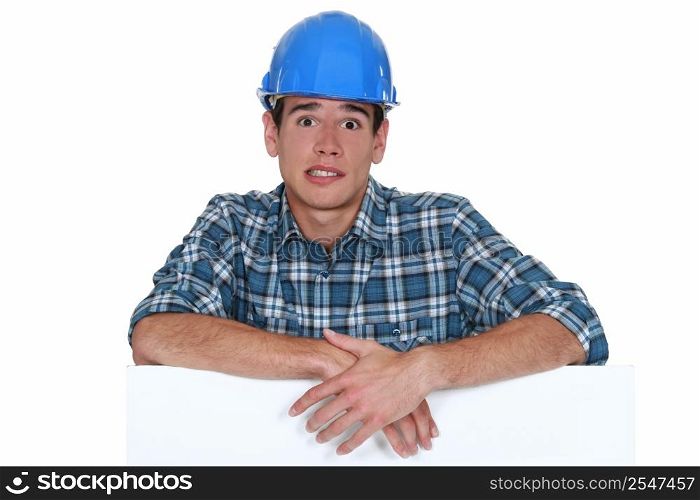 Anxious builder stood with blank board