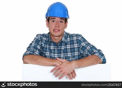 Anxious builder stood with blank board