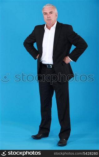 anxious businessman standing on blue background