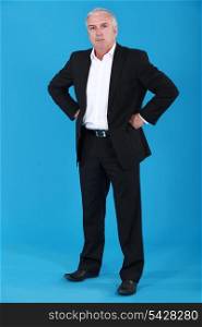 anxious businessman standing on blue background
