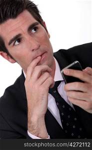 Anxious businessman with mobile phone