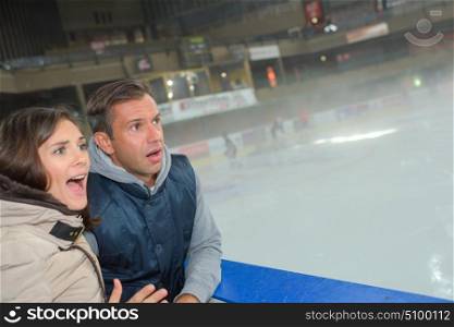 Anxious couple watching game on ice