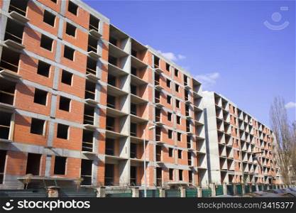 Apartment block with concrete frame and brick walls under construction