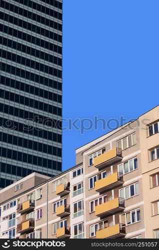 Apartment building and corporate skyscraper in the background, abstract urban scenery in Warsaw downtown, Poland.