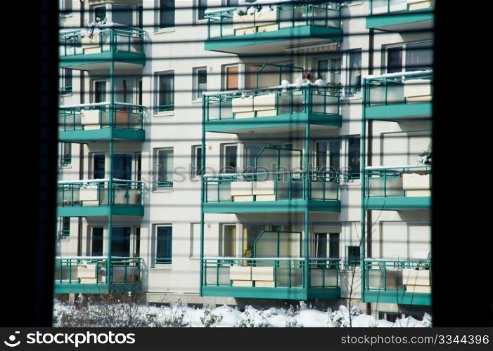 Apartment building seen through blinds