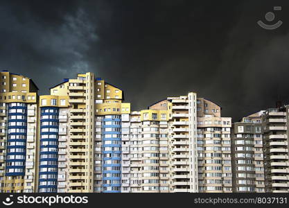 Apartment building under the heavy black rainy clouds