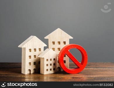 Apartment buildings and red prohibition symbol NO. Emergency and unsuitable for living building. Unavailable expensive housing. Lack of living space and the impossibility of building a new houses.