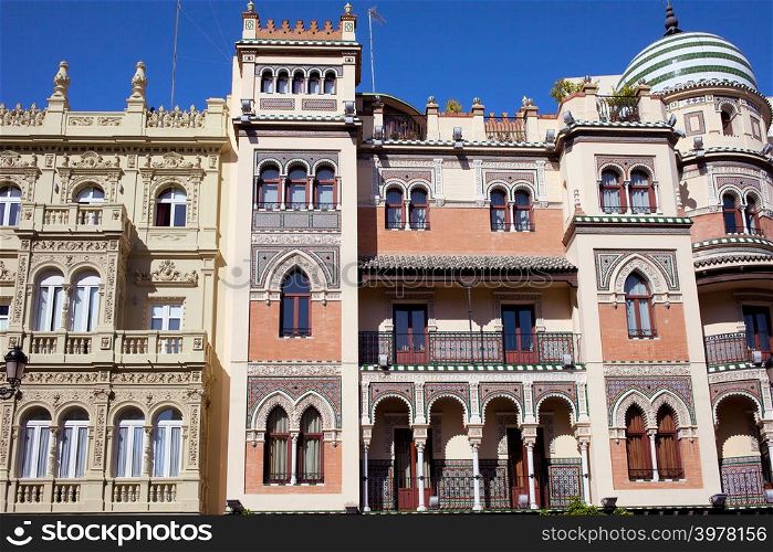 Apartment houses traditional facade in El Arenal historic quarter of Seville, Spain.