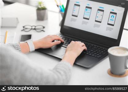 app design, technology and business concept - web designer or developer with templates on laptop computer screen working on user at office. web designer with laptop working on user interface