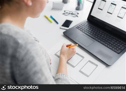 app design, technology and business concept - web designer working on user interface and creating layout at office. web designer working on user interface at office