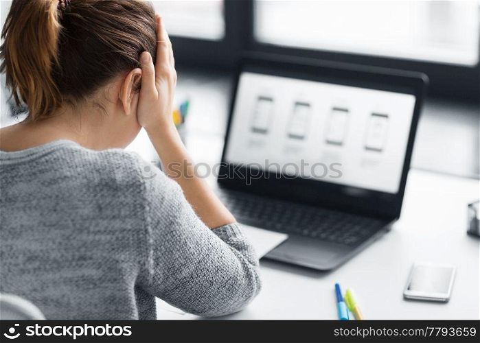 app design, technology and failure concept - stressed web designer with user interface layout on laptop computer screen at office. stressed designer with user interface on laptop
