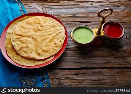 Appalam or Papadam brad with red and green sauces from Indian food papad