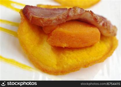 Appetizer: A slice of ham on mashed sweet potato and sweet potato chip (Very Shallow Depth of Field) . Ham with Sweet Potato