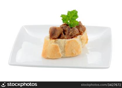 appetizer dish typical of the spanish cuisine of pork on slice of bread cut off and isolated